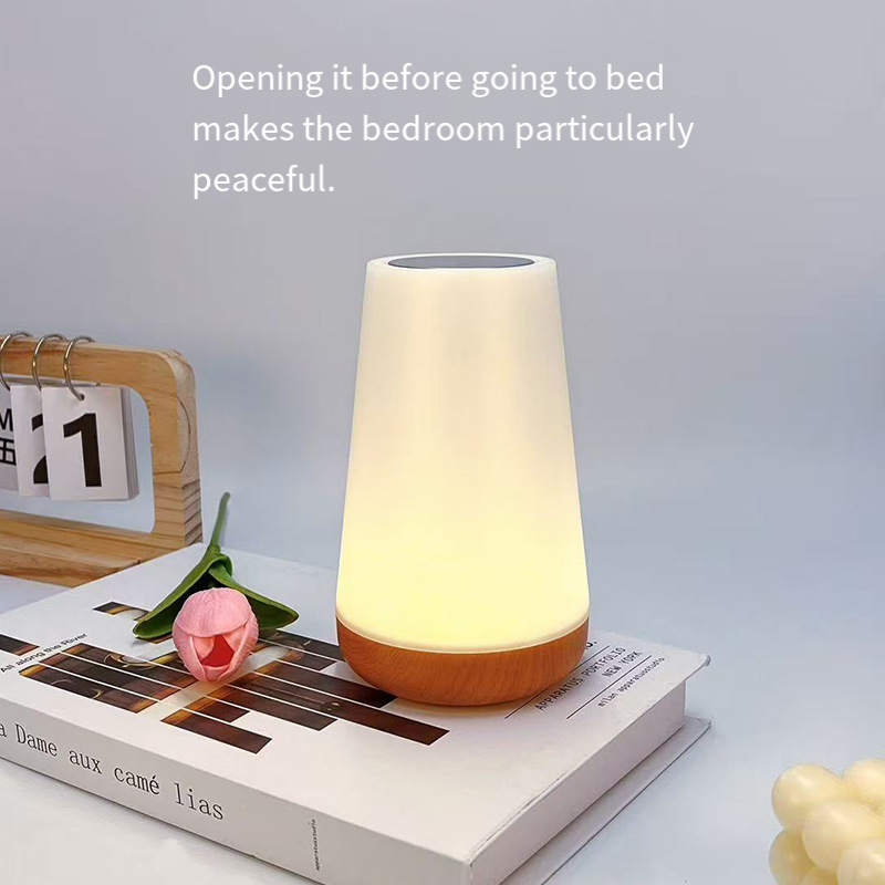 White night light on a book with a soft glow, placed on a light gray background.